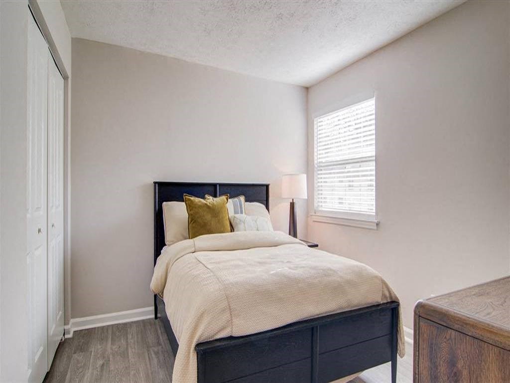 a bedroom with a bed and a window