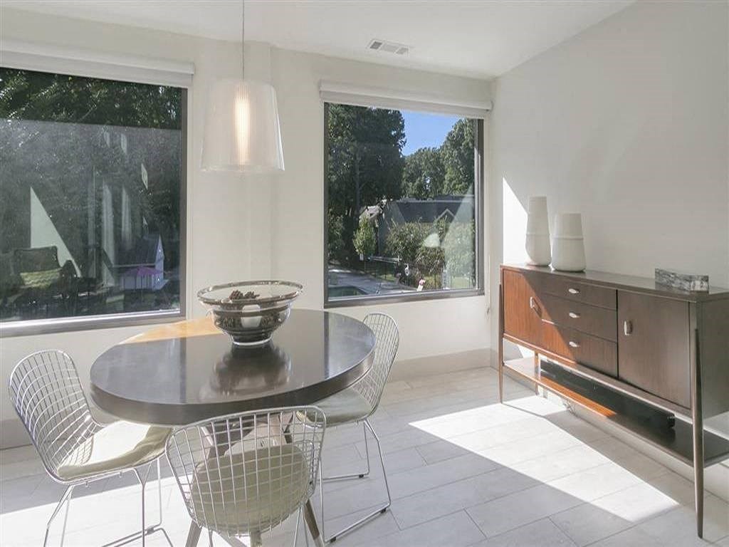 a dining room with a table and chairs