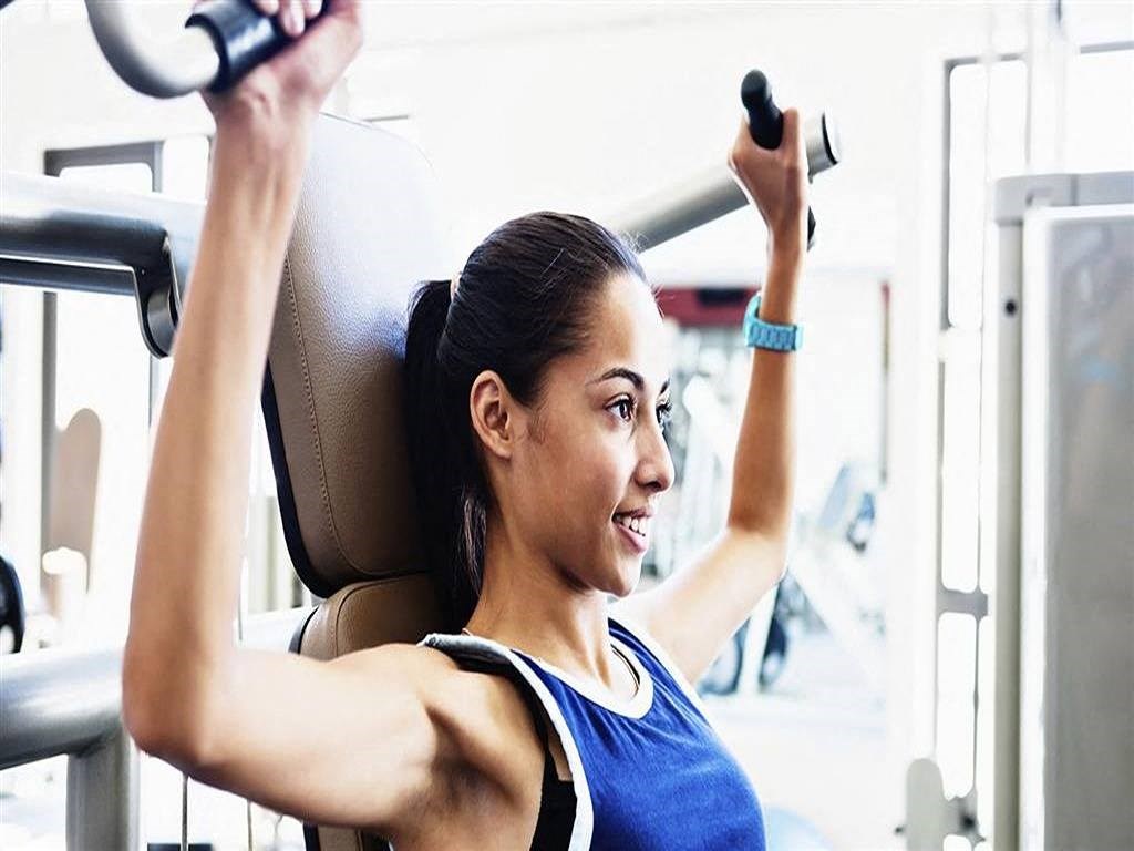 a woman lifting weights in a gym