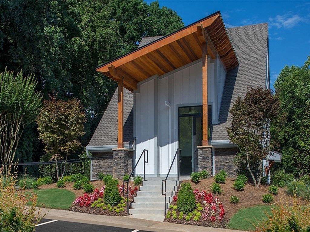 the front of a house with a porch and stairs