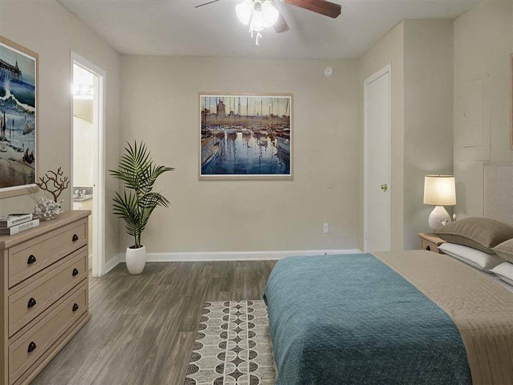 a bedroom with a bed and a painting on the wall