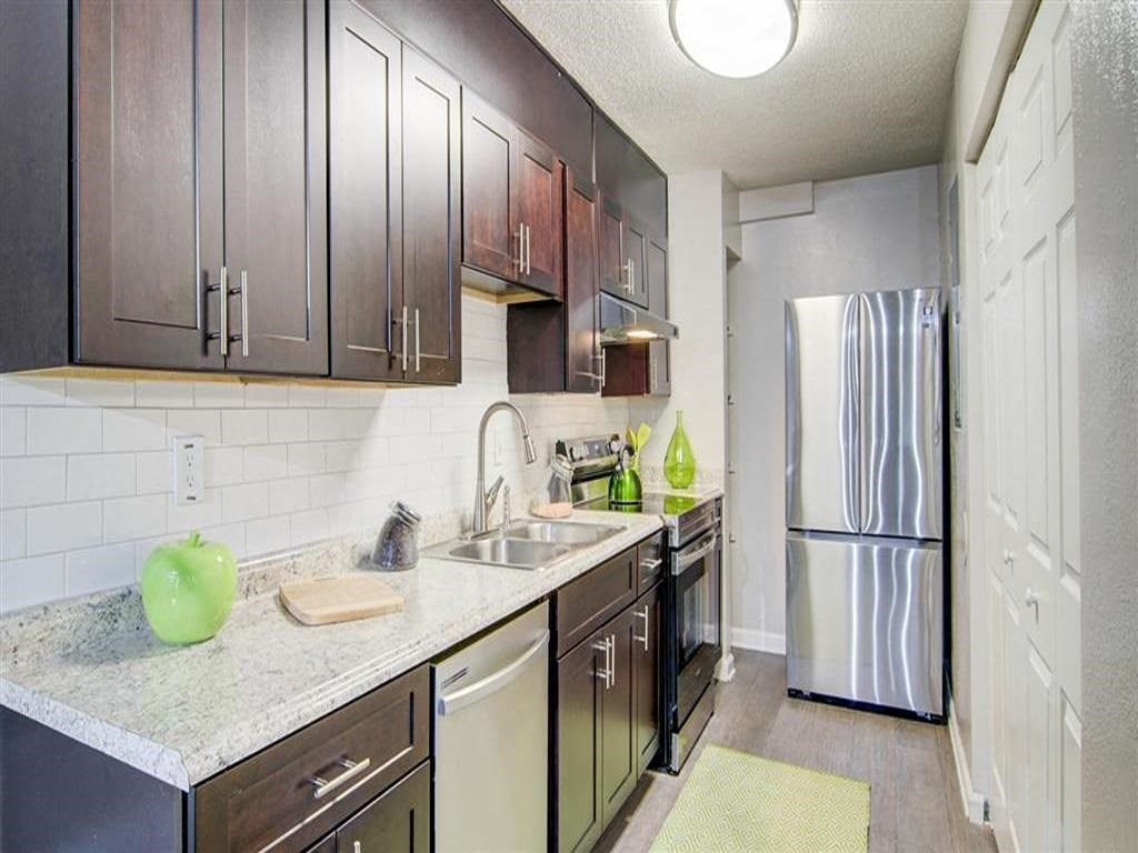 a kitchen with a sink and a refrigerator