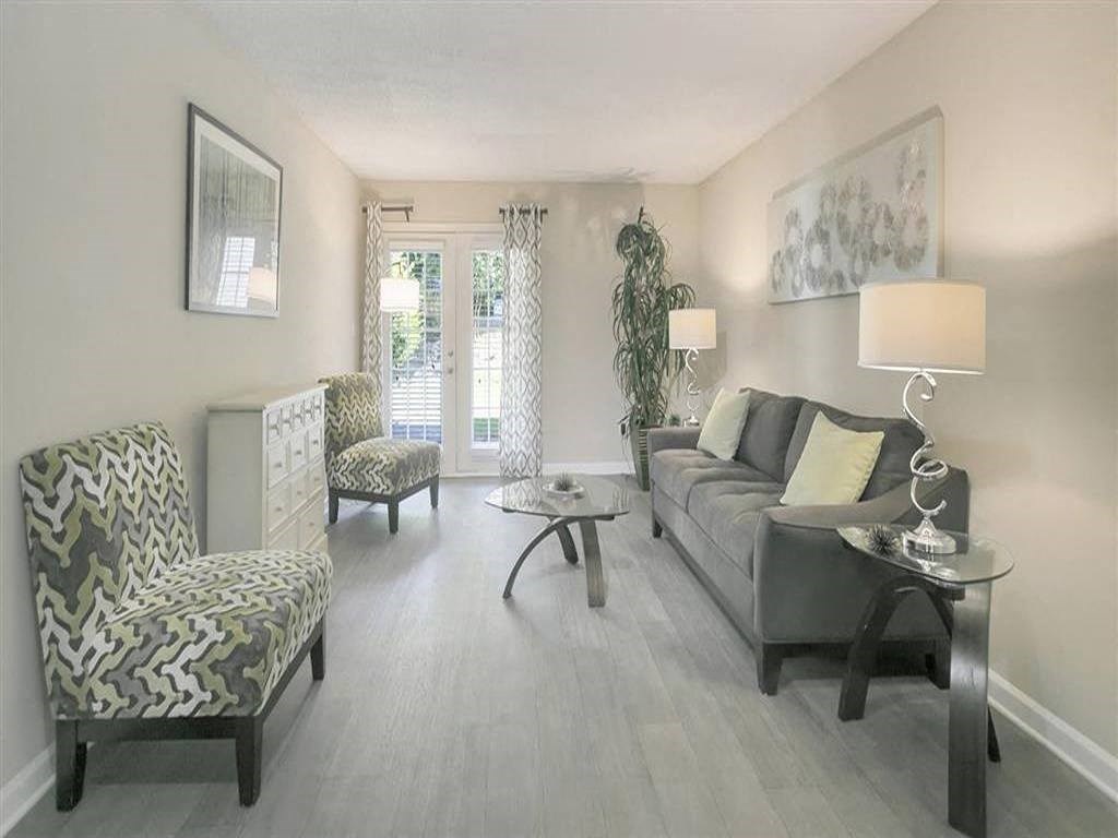 a living room with a couch and two chairs