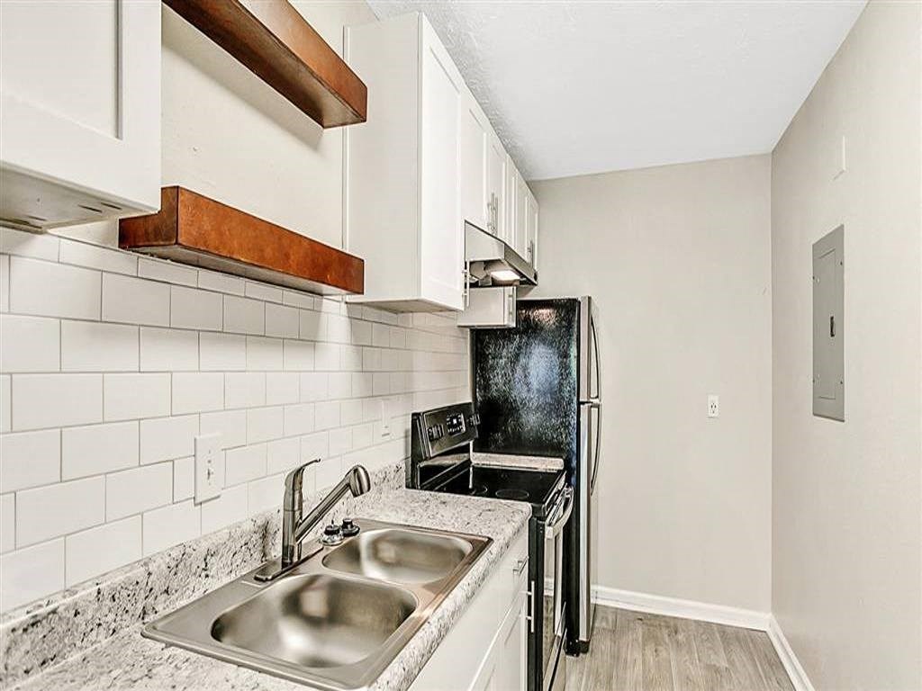 a kitchen with a sink and a refrigerator
