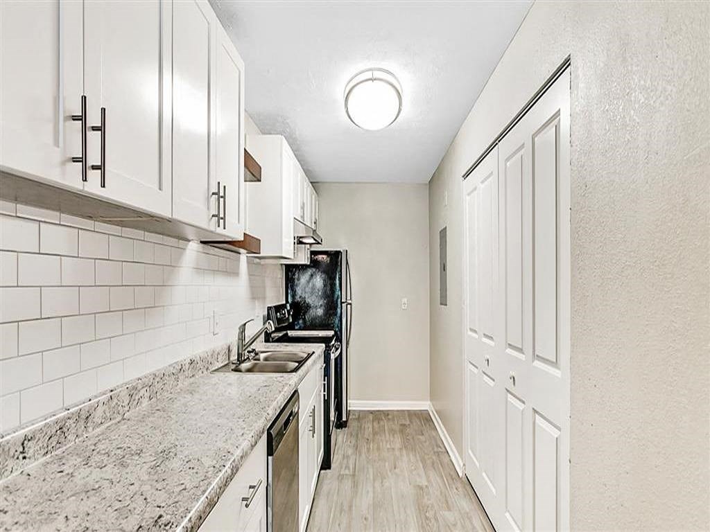 a kitchen with a stove and a sink