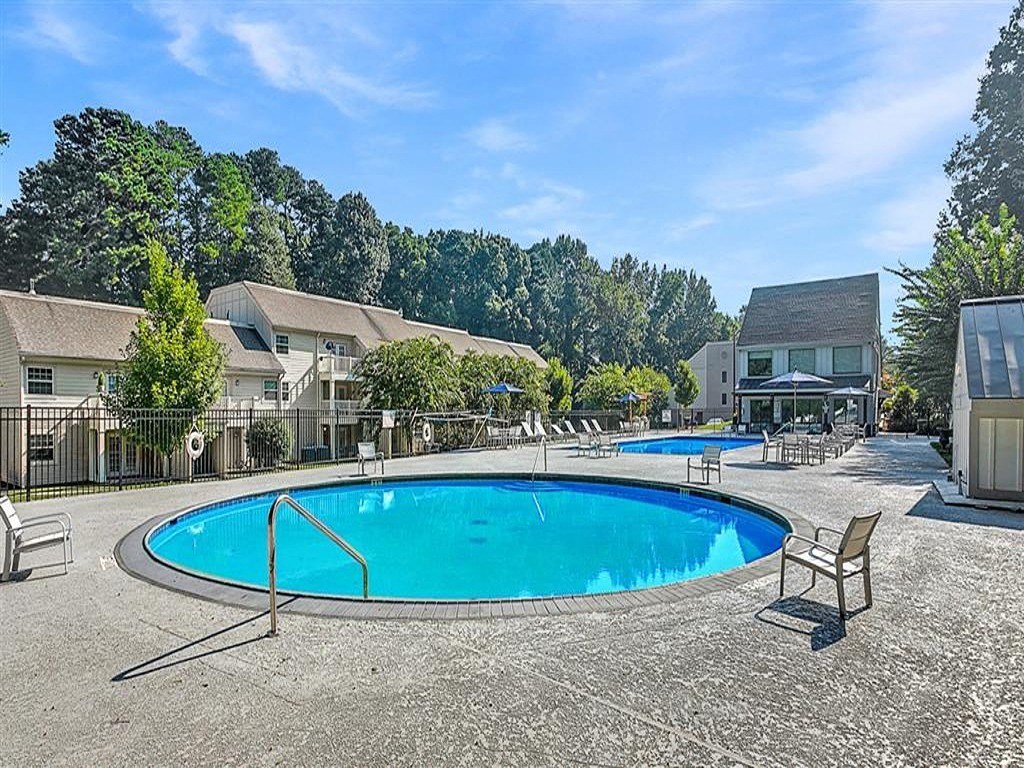 a resort style swimming pool with chairs around it