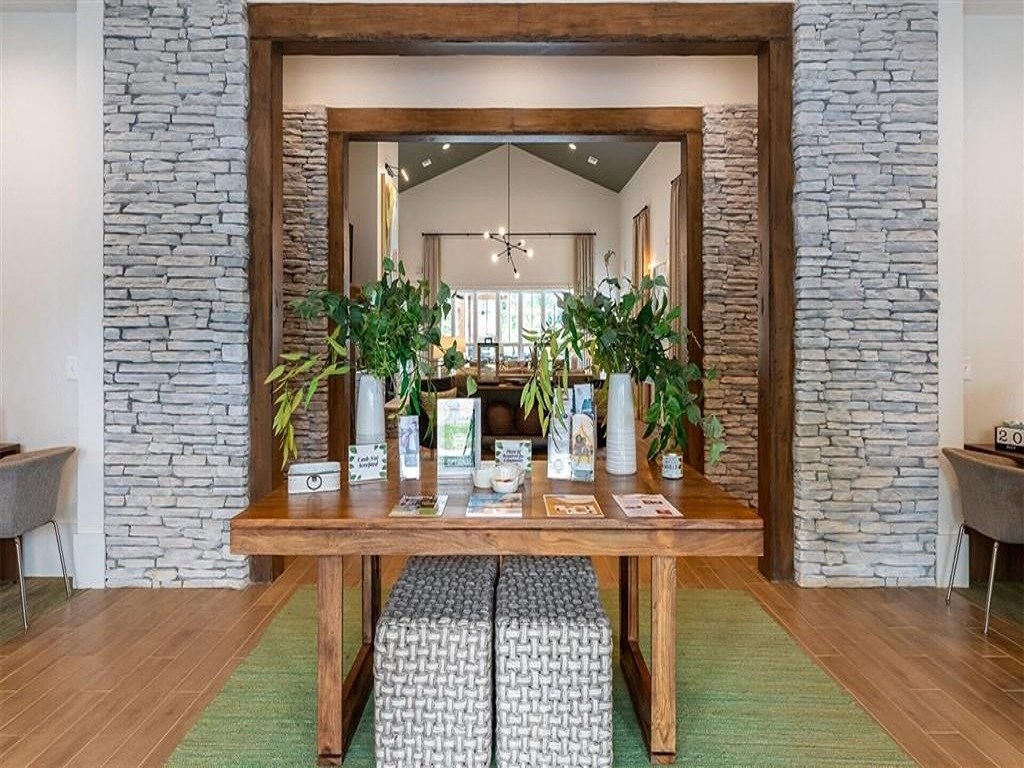 a dining room with a wooden table and a large mirror