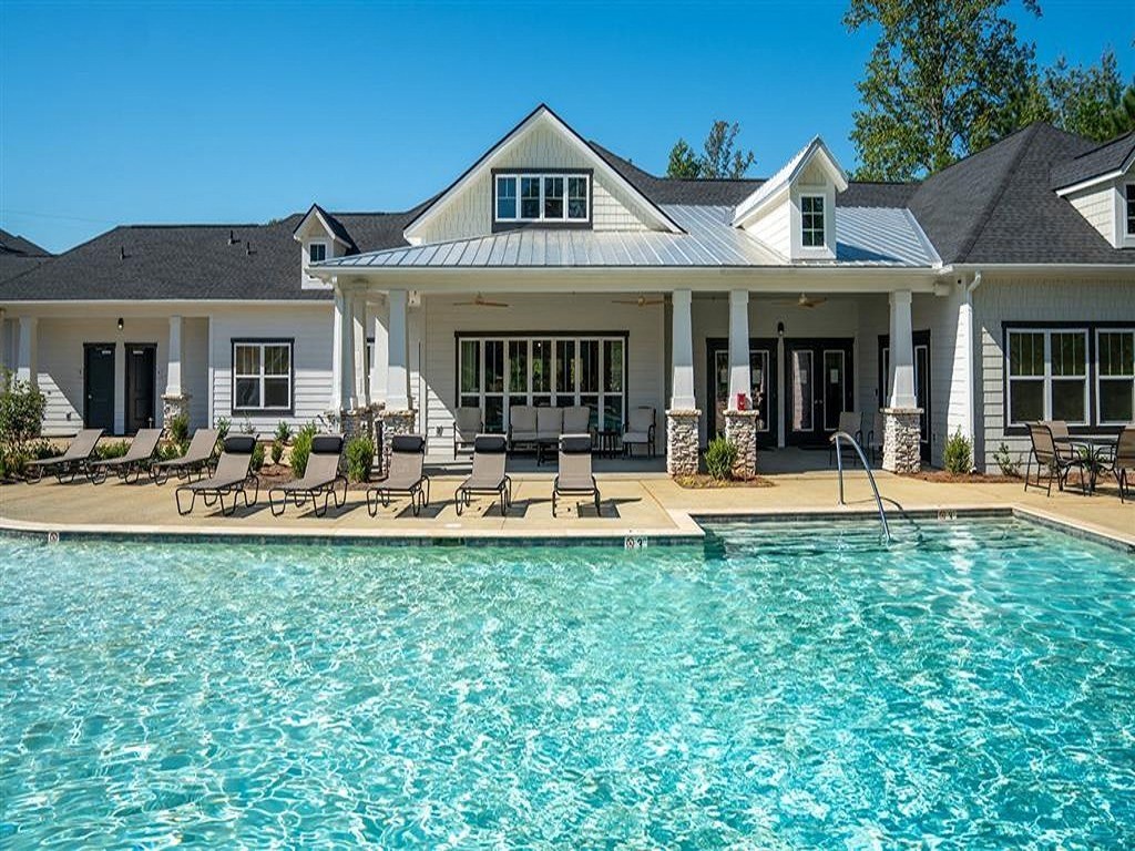 a large swimming pool in front of a house
