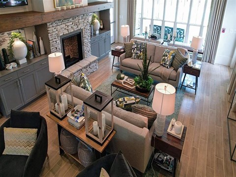 a living room with couches and tables and a fireplace