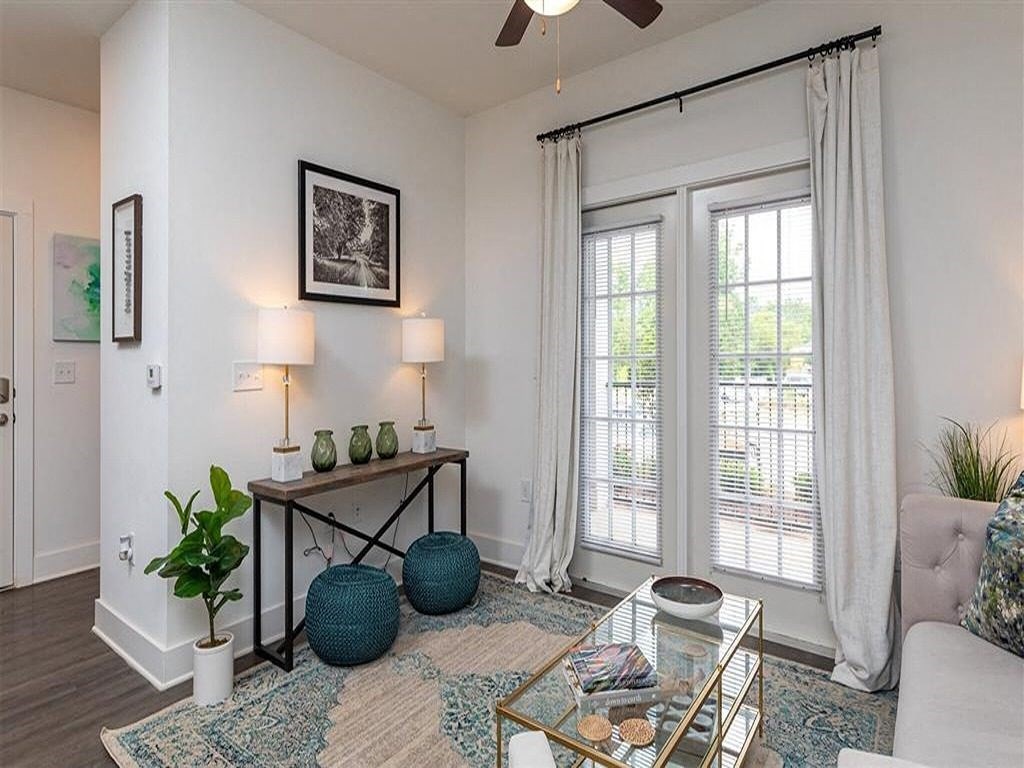a living room with a large window and a table