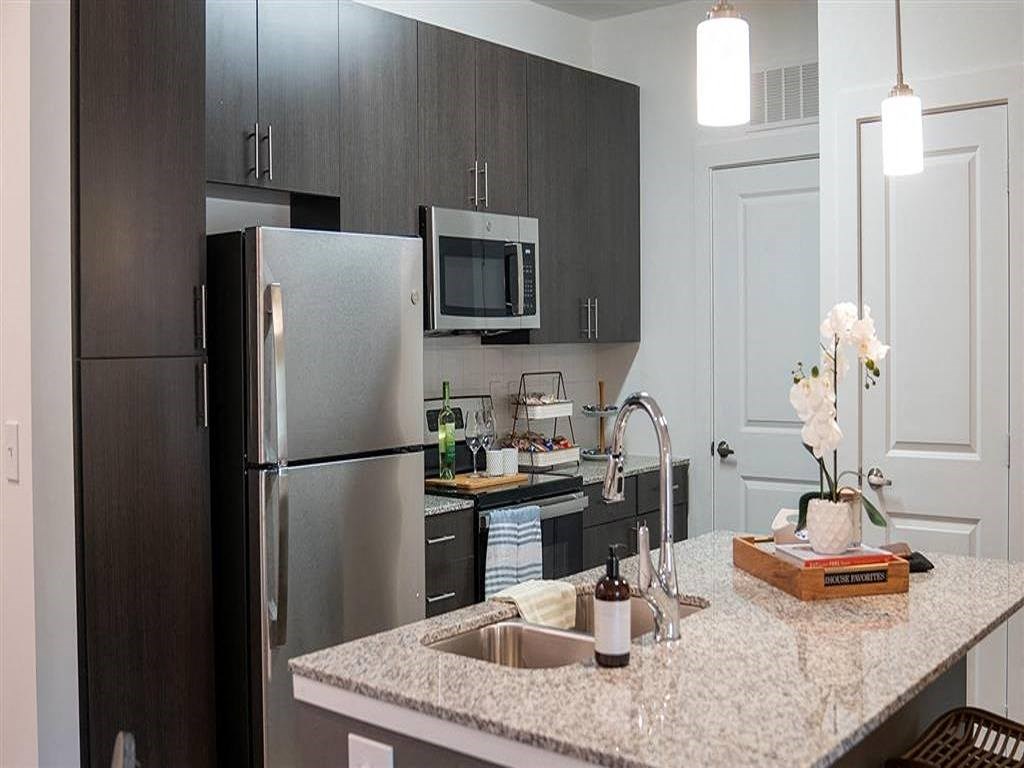 a kitchen with a sink and a refrigerator