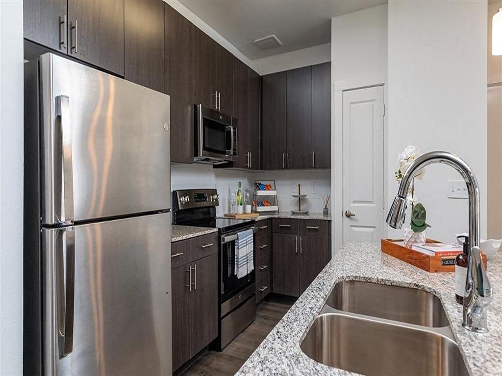 a kitchen with stainless steel appliances and a sink