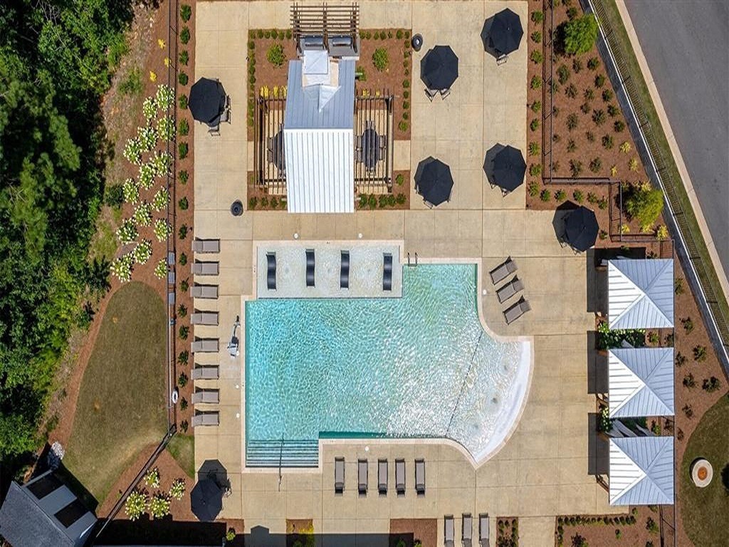 an aerial view of a swimming pool in a yard