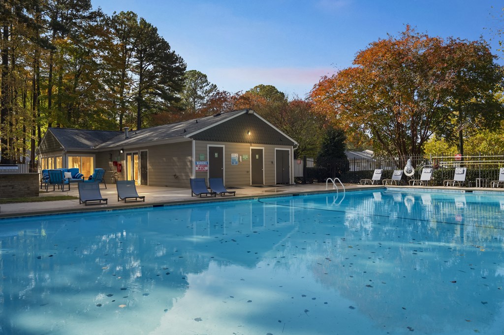 a swimming pool with a house in the background