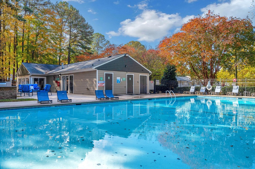 the swimming pool at our apartments with a clubhouse and a pool house