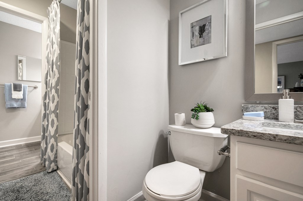 a bathroom with a toilet and a shower and a sink