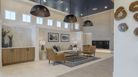 A living room with a couch, chairs, and a rug.