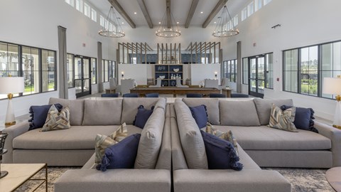 A large, modern living room with a long couch and a coffee table.