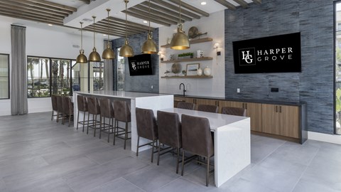 A modern kitchen with a long table and chairs.