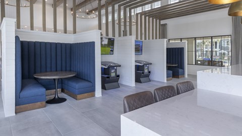 A modern dining area with a white table and blue chairs.