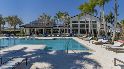 A large swimming pool with a building in the background.
