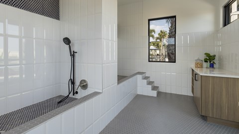 A bathroom with a walk-in shower and a window.