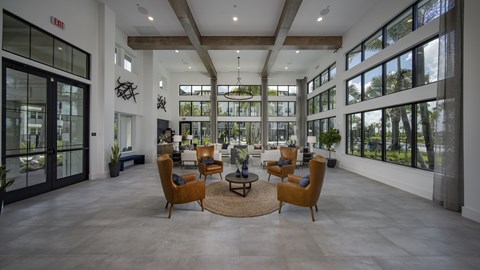 A large room with a glass wall and a table with chairs in front of it.