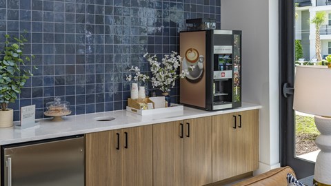 A modern kitchen with a stainless steel refrigerator and wooden cabinets.