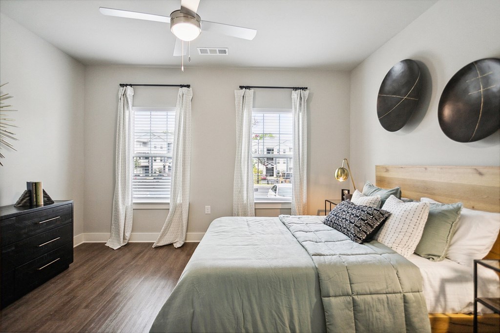 a bedroom with a large bed and a ceiling fan
