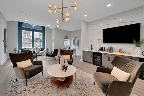 a living room with couches and chairs and a tv