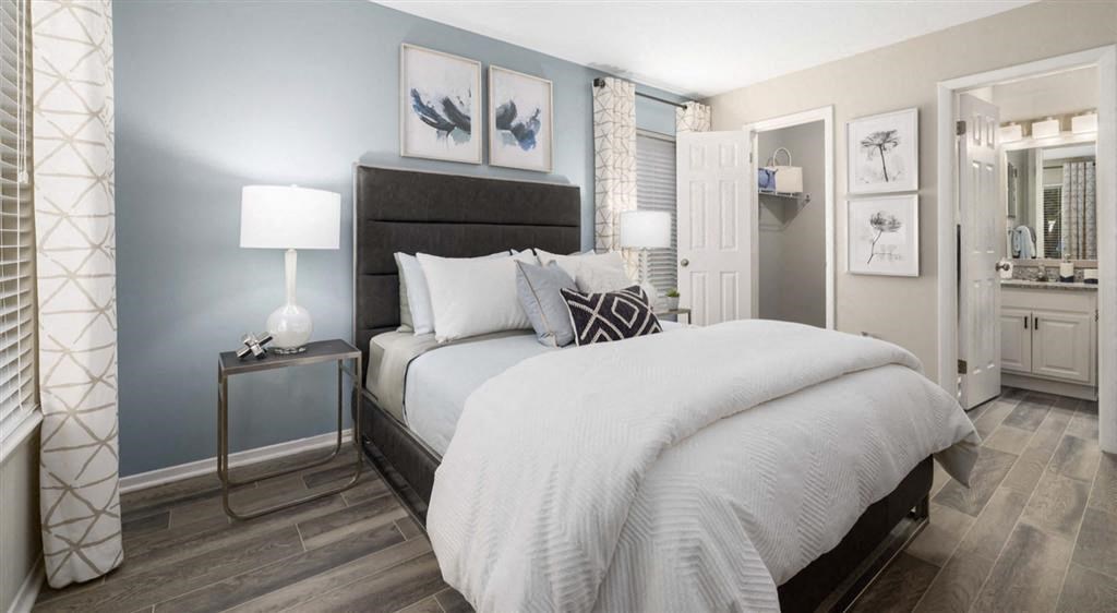 a bedroom with a large bed and a mirror