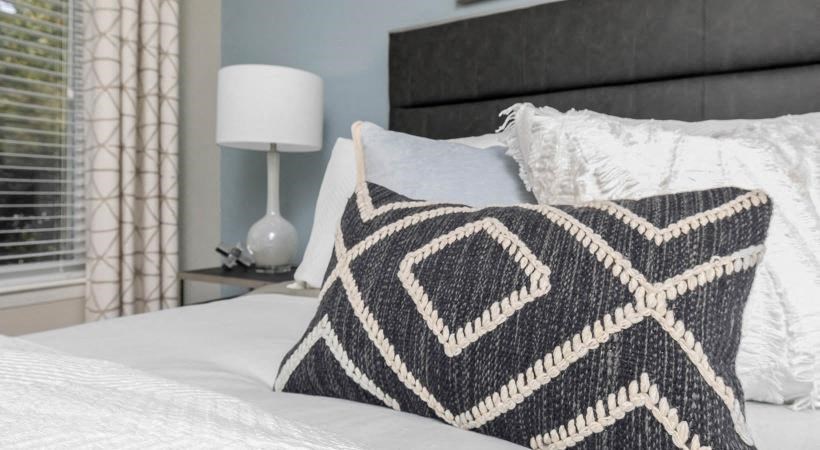 a bed with a blanket and pillows on it