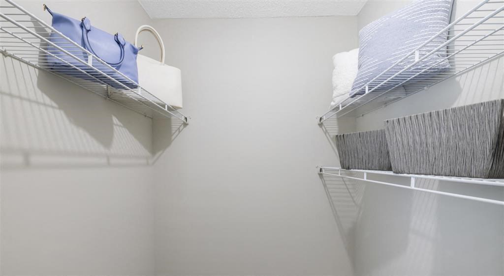 an empty closet with two wire baskets on the wall