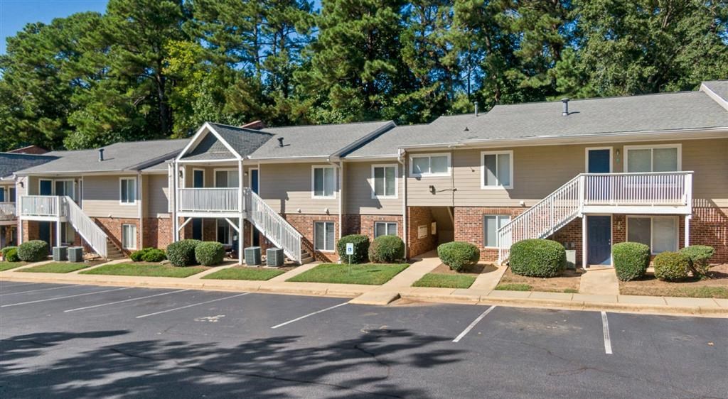 a street view of an apartment complex with stairs and balconies