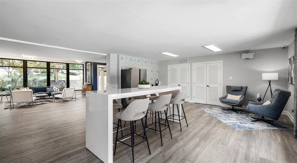 a living room with a bar and a kitchen