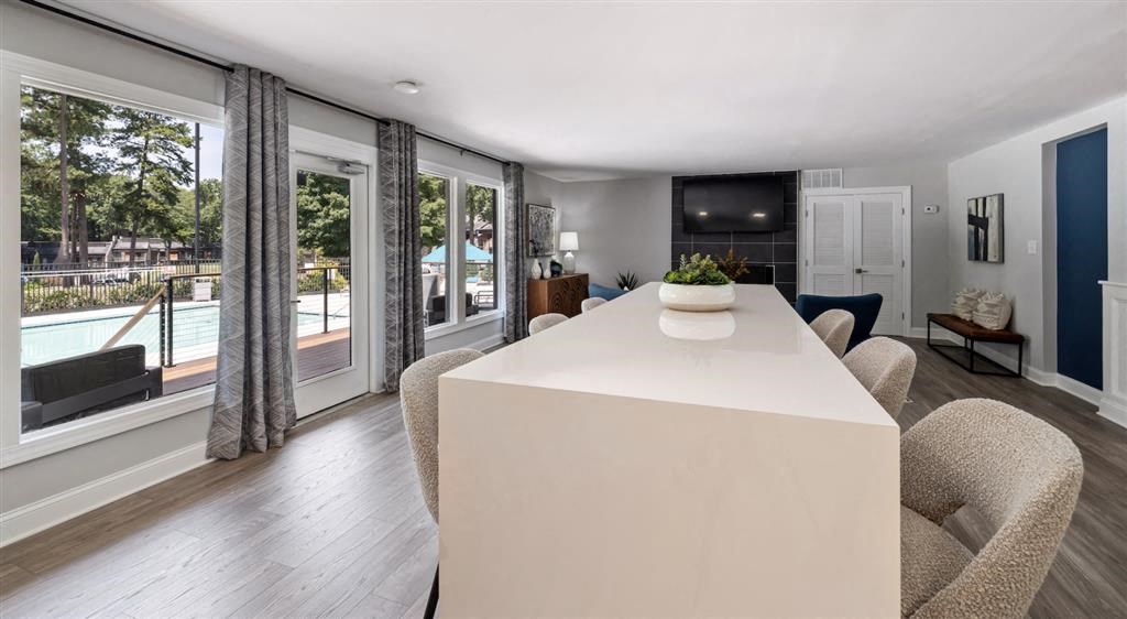 a living room with a white table and a pool