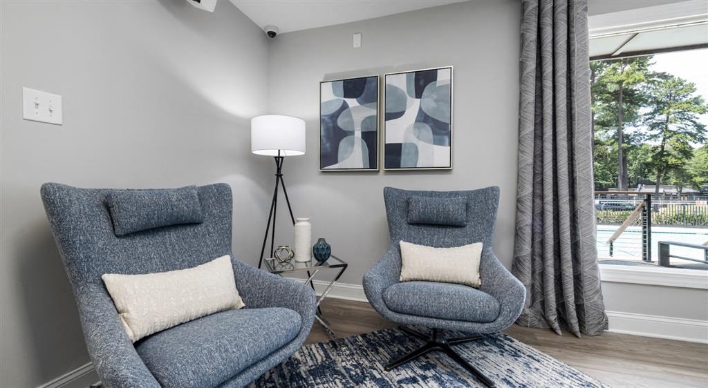 a living room with two chairs and a window