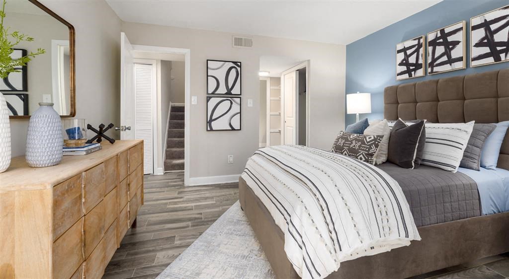 a bedroom with a bed and a dresser