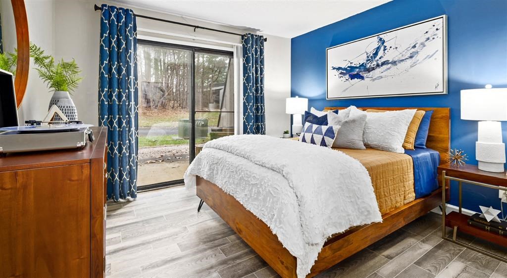 a bedroom with a bed and a sliding glass door