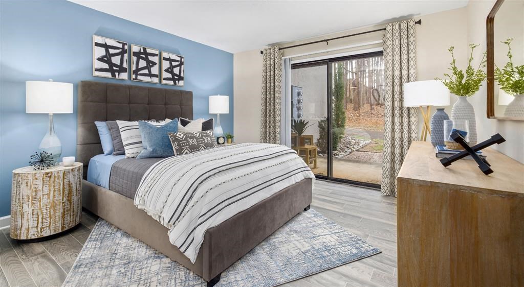 a bedroom with a bed and a sliding glass door