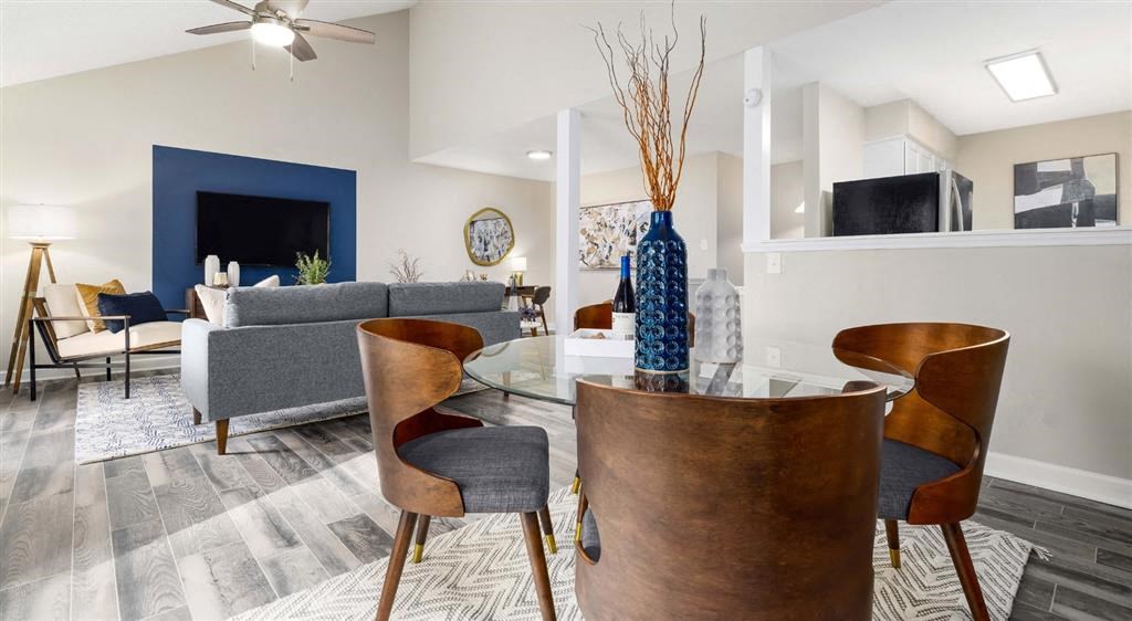 a living room and dining room with a table and chairs
