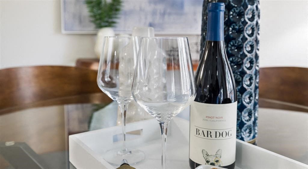 a bottle of wine and wine glasses on a table