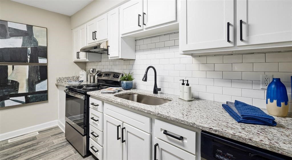a kitchen with white cabinets and a sink