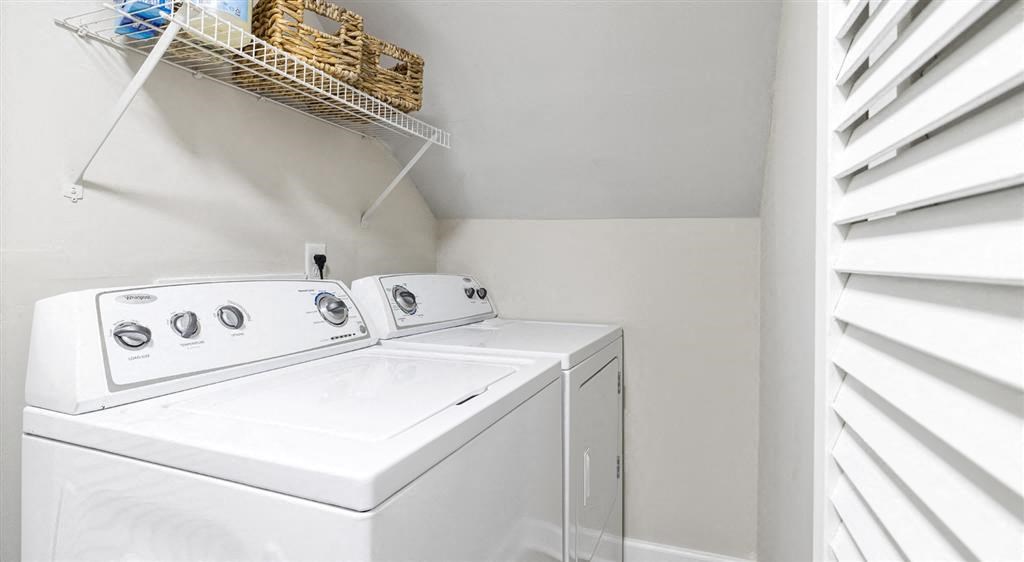 a white washer and dryer in a white laundry room