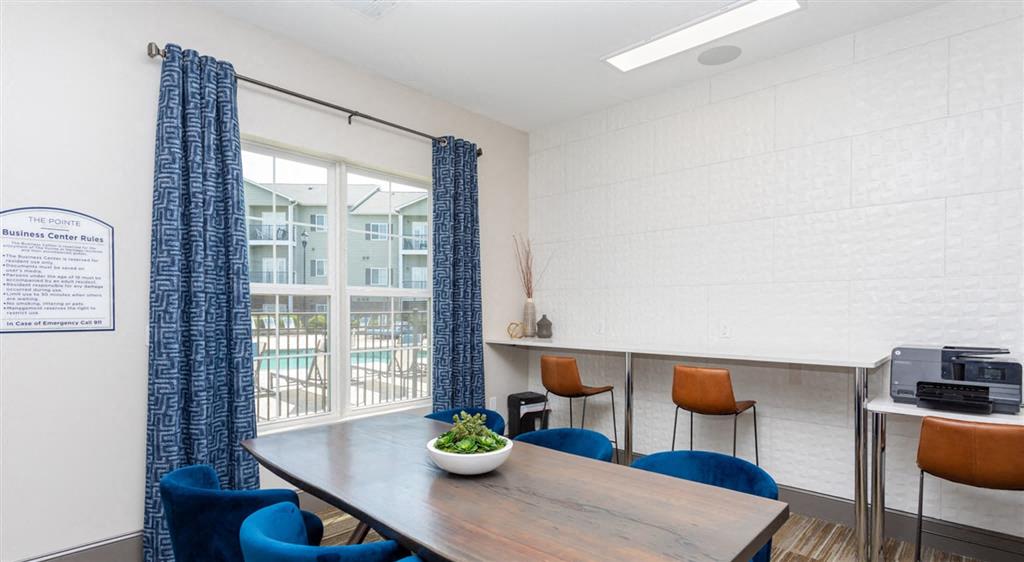 a dining room with a table and chairs and a window
