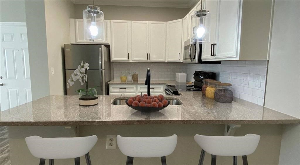 a kitchen with a counter with a bowl of fruit on it