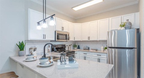 a kitchen with a counter top and a refrigerator