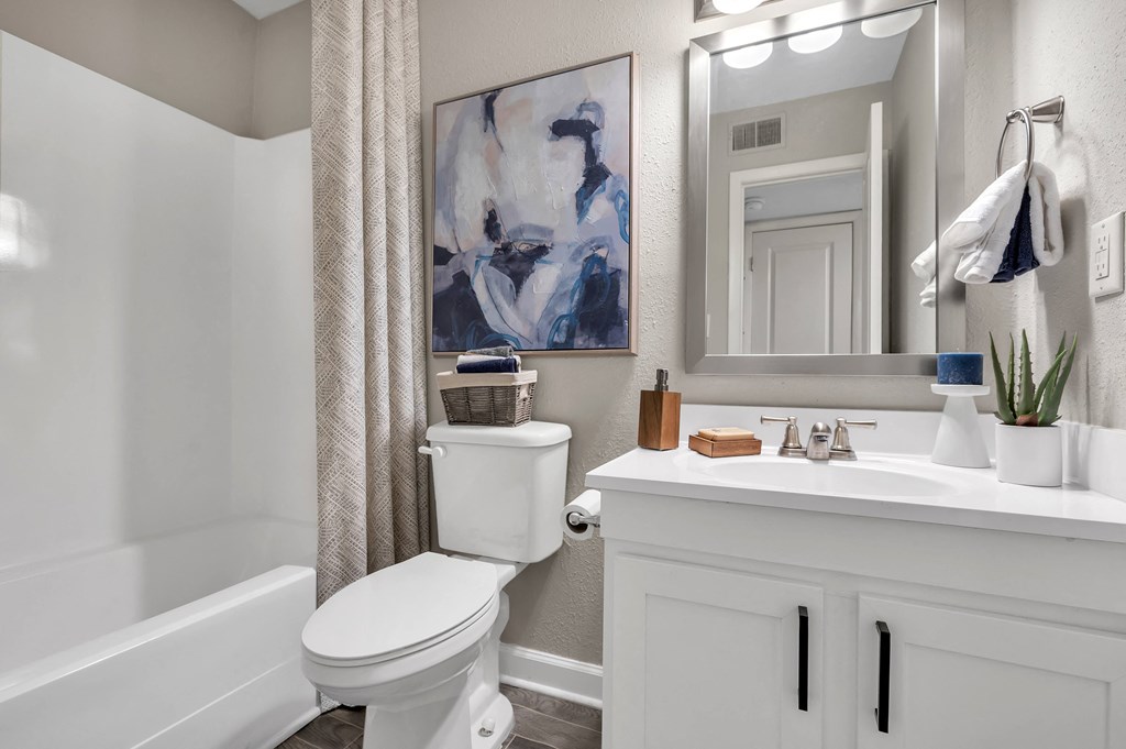 a bathroom with a white toilet and a sink