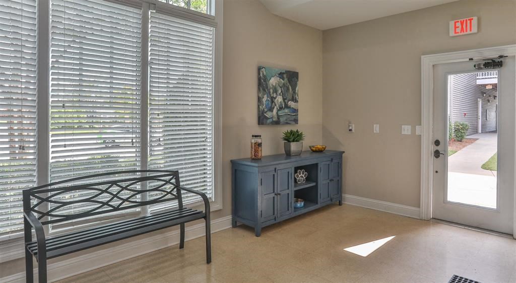 a room with a bench and a window and a door