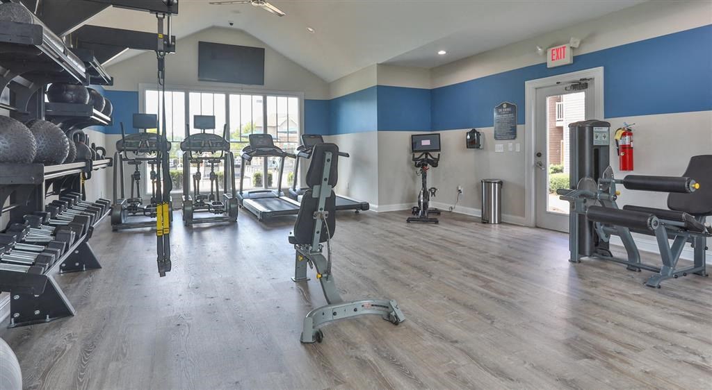 a gym with weights and other exercise equipment and a window